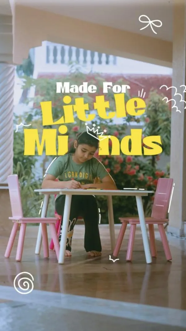 Made for little minds: a girl draws at a white study table with pink chairs.