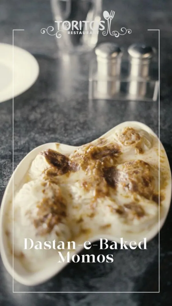 Kitchen to table: 'Dastan-e-Baked Momos', bubbling from the oven.