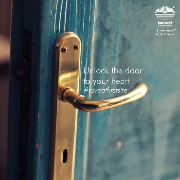 Brass handle on a weathered blue door, 'Unlock the door to your heart'.