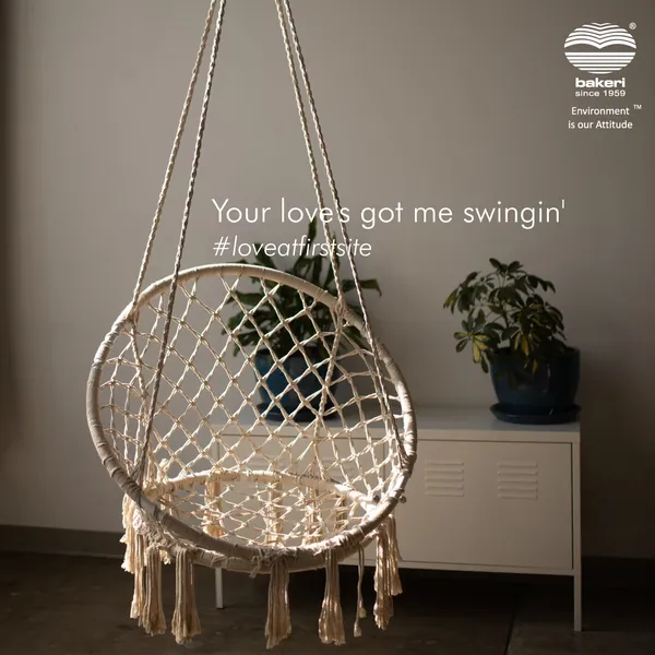 Macramé hanging chair beside a plant, a Valentine pun about love that gets you swinging.