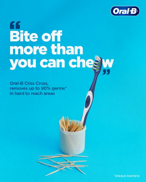 Toothpicks spill beside a Criss Cross manual brush: 'Bite off more than you can chew'.