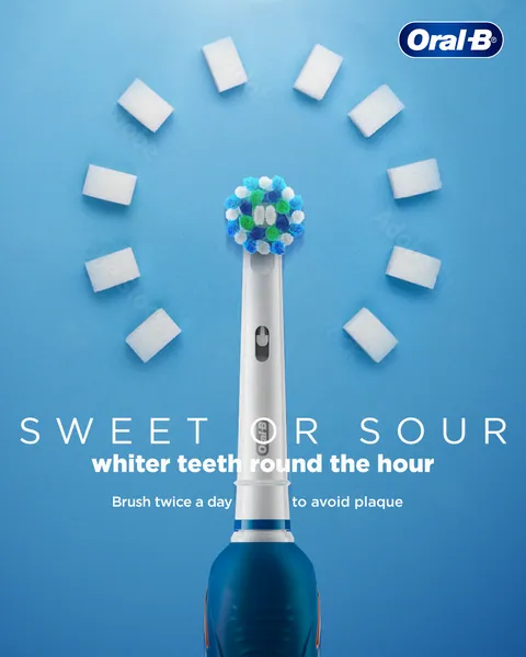 Sugar cubes ring a brush head like a clock face: 'whiter teeth round the hour'.