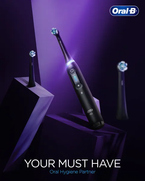 A black iO brush on angular purple plinths, billed 'Your must have' oral hygiene partner.