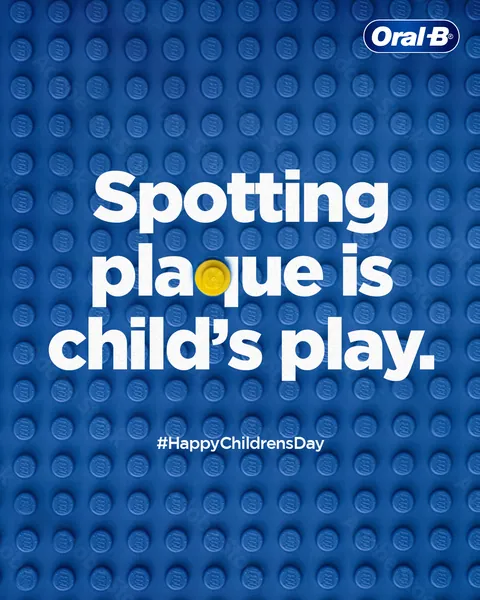 Children's Day: blue toy bricks and a yellow stud say 'Spotting plaque is child's play'.