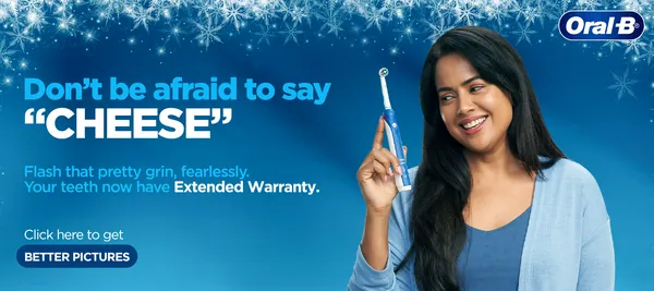 Frosty banner with a smiling woman and her electric brush: 'Don't be afraid to say "CHEESE"'.