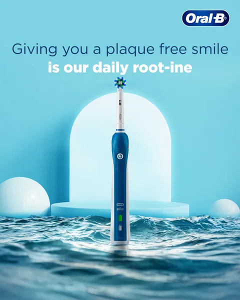 Rising from waves before an arch, a blue electric brush delivers 'our daily root-ine'.