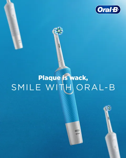 Electric brushes float at angles on blue under the line 'Plaque is wack'.
