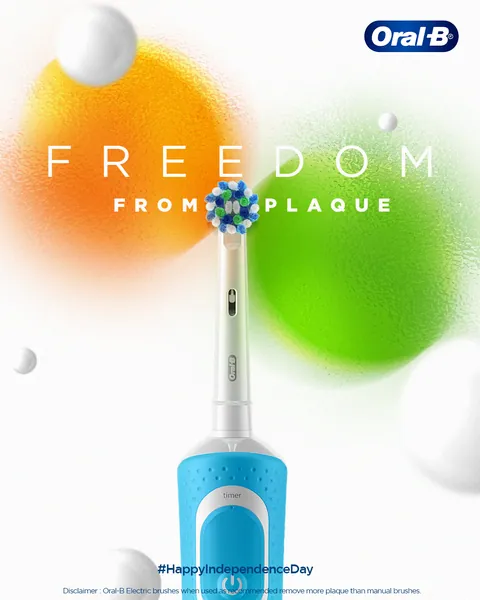 Independence Day: saffron and green orbs frame a blue electric brush, 'Freedom from plaque'.