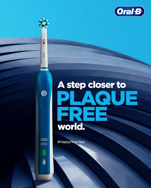 New Year: a blue electric brush on curving steps, 'A step closer to plaque free world'.