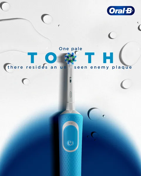 A blue electric brush head forms an 'O' in 'One pale tooth', amid water droplets.