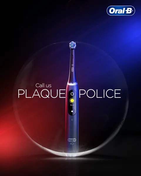 Red and blue siren light hits an iO brush in a bubble: 'Call us plaque police'.