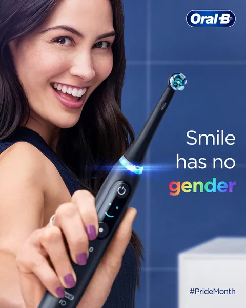 Pride Month post: a smiling woman holds out a brush, 'Smile has no gender'.