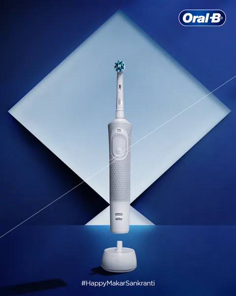 Makar Sankranti: a white electric toothbrush framed by a glowing kite and its string.