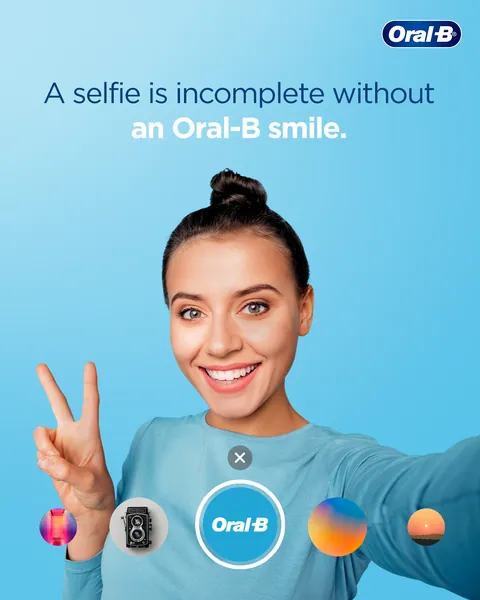 Selfie Day: a peace-sign selfie with an Oral-B lens filter, 'incomplete without an Oral-B smile'.