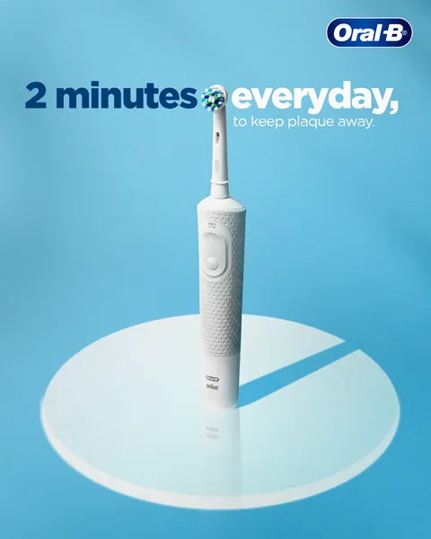 A white Oral-B electric brush stands on a clock-like dial: '2 minutes everyday'.