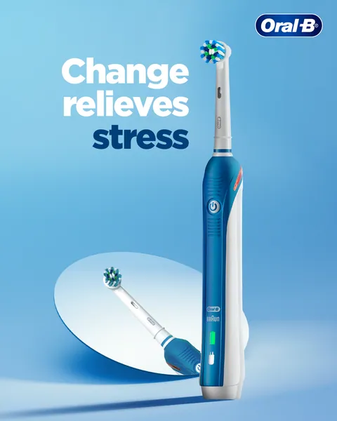 A blue electric brush rises over a mirrored disc with the line 'Change relieves stress'.