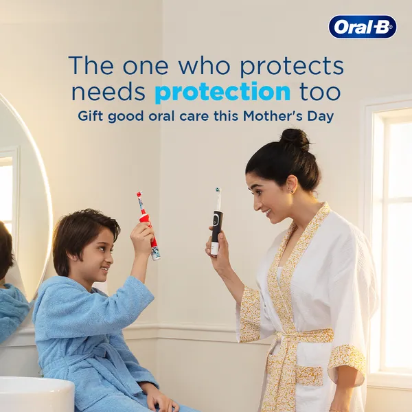 Mother and son raise electric brushes in the bathroom: 'Gift good oral care this Mother's Day'.