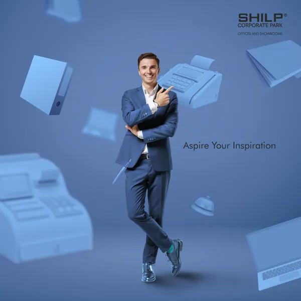 Shilp Corporate Park: a smiling businessman among floating blue office gear, 'Aspire your inspiration'.