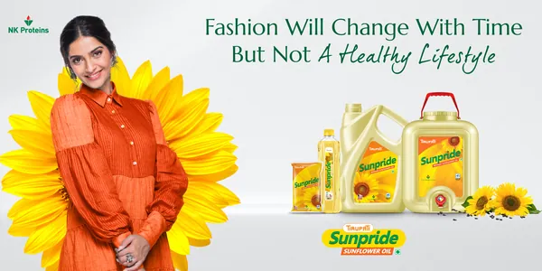 Sunpride hoarding: a woman before a giant sunflower with oil packs, 'fashion will change with time'.
