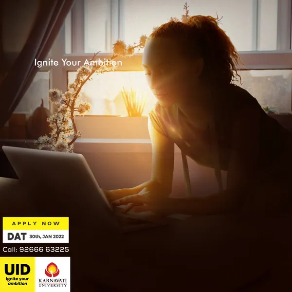 A woman works on a laptop by a sunlit window, part four of 'Ignite Your Ambition'.