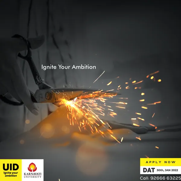 UID admissions: shears throw off sparks as they cut, under the line 'Ignite Your Ambition'.